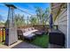 This spacious deck features cushioned seating, patio heater, string lights, and artificial grass at 11715 W 30Th Pl, Lakewood, CO 80215