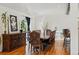 Spacious dining area with hardwood floors, a long wooden table with seating for ten, and elegant decor at 11715 W 30Th Pl, Lakewood, CO 80215