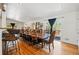 Bright and airy dining space with hardwood floors, large wooden table, and access to outdoor deck at 11715 W 30Th Pl, Lakewood, CO 80215
