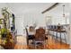 Elegant dining room featuring hardwood floors, a long wooden table, and stylish furnishings at 11715 W 30Th Pl, Lakewood, CO 80215