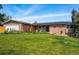 Inviting exterior of a brick and siding home with solar panels, a well-manicured lawn, and a two-car garage at 11715 W 30Th Pl, Lakewood, CO 80215