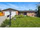Charming single-Gathering home featuring a well-maintained front yard, brick accents, and solar panels at 11715 W 30Th Pl, Lakewood, CO 80215