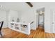Bright hallway with hardwood floors, built-in shelving, and access to multiple rooms at 11715 W 30Th Pl, Lakewood, CO 80215