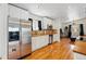 Bright kitchen with stainless steel appliances, white cabinets, and hardwood flooring at 11715 W 30Th Pl, Lakewood, CO 80215