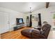 Cozy living room with a leather sofa, hardwood floors, a beamed ceiling and lots of natural light at 11715 W 30Th Pl, Lakewood, CO 80215