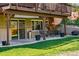 Cozy outdoor patio area with seating and a wood pile for a fireplace, creating a relaxing ambiance at 11715 W 30Th Pl, Lakewood, CO 80215