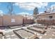 A brick house features a spacious backyard with stone walkway and numerous raised garden beds and a privacy fence at 1462 Eudora St, Denver, CO 80220