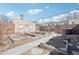 This backyard has several garden beds and a walkway. The yard is fenced in with access to a brick building at 1462 Eudora St, Denver, CO 80220