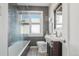 Stylish bathroom features a shower with glass door, wood vanity and unique fixtures at 1462 Eudora St, Denver, CO 80220