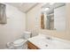 Well-lit bathroom featuring a sink, toilet, and shower with glass door at 1462 Eudora St, Denver, CO 80220