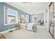 Relaxing bedroom featuring a large window, ensuite sitting area and closet with mirrored sliding doors at 1462 Eudora St, Denver, CO 80220