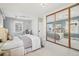 Bright bedroom featuring a large window, ensuite sitting area and closet with mirrored sliding doors at 1462 Eudora St, Denver, CO 80220