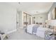 Bright bedroom featuring a large window, ensuite sitting area and closet with mirrored sliding doors at 1462 Eudora St, Denver, CO 80220