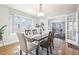 Bright dining room featuring hardwood floors, neutral paint, and an open doorway to the living room at 1462 Eudora St, Denver, CO 80220