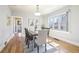 Bright dining room with hardwood floors, modern lighting, and ample natural light from a large window at 1462 Eudora St, Denver, CO 80220