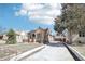 Charming brick home featuring solar panels, long driveway, and a detached garage at 1462 Eudora St, Denver, CO 80220