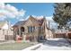 Charming brick home featuring solar panels, landscaped front yard, and a detached garage at 1462 Eudora St, Denver, CO 80220