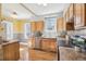 Kitchen featuring wooden cabinets, stainless steel appliances, hardwood floors, and lots of light at 1462 Eudora St, Denver, CO 80220
