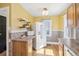 Cozy kitchen with light wood floors, bright yellow walls and modern appliances at 1462 Eudora St, Denver, CO 80220