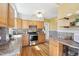 Bright kitchen with natural wood cabinets, stainless steel appliances, and hardwood floors at 1462 Eudora St, Denver, CO 80220