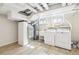 Functional laundry room with washer, dryer, sink, and utility connections at 1462 Eudora St, Denver, CO 80220