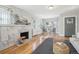 Bright living room featuring hardwood floors, a decorative fireplace, and natural light at 1462 Eudora St, Denver, CO 80220