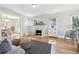 Living room featuring hardwood floors, a decorative fireplace, and view to dining area at 1462 Eudora St, Denver, CO 80220