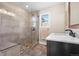 Modern bathroom featuring a glass enclosed shower with bench, neutral tiling, and marble counter at 4204 Morning Star Dr, Castle Rock, CO 80108