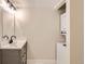 Bathroom vanity with a laundry unit including a washing machine and a dryer at 909 S Dawson Way # 2, Aurora, CO 80012