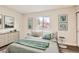 Bright bedroom features updated hardwood floors, a large window, and stylish modern furniture at 909 S Dawson Way # 2, Aurora, CO 80012