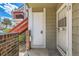 Condo front door with exterior brick and painted wood detailing and a secured screen door at 909 S Dawson Way # 2, Aurora, CO 80012