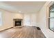 Cozy living room showcasing wood-look flooring, a fireplace, and a bright window at 909 S Dawson Way # 2, Aurora, CO 80012