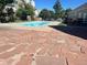 Community pool surrounded by mature trees and lush landscaping on a sunny day at 909 S Dawson Way # 2, Aurora, CO 80012