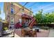 Multi-story brick home with fenced-in backyard featuring brick and stone patios and stairways at 1438 N Franklin St # 100, Denver, CO 80218