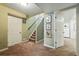 Basement with stairs and bedroom access, featuring carpeting and wall decor at 1438 N Franklin St # 100, Denver, CO 80218