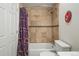 Clean bathroom with a shower tub, decorative curtain and neutral tilework at 1438 N Franklin St # 100, Denver, CO 80218