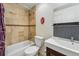 Well-lit bathroom featuring neutral tile, a shower-tub combination, and a modern vanity at 1438 N Franklin St # 100, Denver, CO 80218