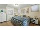 Cozy bedroom features natural light, decorative artwork, and a comfortable bed with patterned bedding at 1438 N Franklin St # 100, Denver, CO 80218