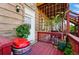 Back deck with a red grill, potted plants, a trellis and a door to the home at 1438 N Franklin St # 100, Denver, CO 80218