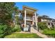 Beautiful brick home featuring prominent columns, a second-story balcony, and a green lawn at 1438 N Franklin St # 100, Denver, CO 80218