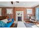 Inviting living room features exposed brick wall, fireplace, and lots of natural light at 1438 N Franklin St # 100, Denver, CO 80218