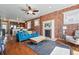 Bright living room boasts exposed brick wall, fireplace, and hardwood floors at 1438 N Franklin St # 100, Denver, CO 80218