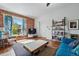 Bright and open living room with hardwood floors, exposed brick, and a modern aesthetic at 1438 N Franklin St # 100, Denver, CO 80218