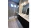 Modern bathroom with a double vanity, sleek cabinets, and a glass-enclosed shower at 16841 Askins Loop # 208, Parker, CO 80134