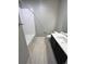Bright bathroom with white tile, modern fixtures, and a bathtub shower combination at 16841 Askins Loop # 208, Parker, CO 80134