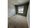 Cozy bedroom featuring a window with neighborhood views and carpeted floors at 16841 Askins Loop # 208, Parker, CO 80134