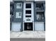 Modern condo building with gray siding, white trim, private balconies, and attached garages for convenient parking at 16841 Askins Loop # 208, Parker, CO 80134