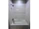 Bathroom shower featuring white-tile walls, shower head, and tub at 16841 Askins Loop # 208, Parker, CO 80134