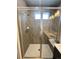 Bathroom shower featuring tile walls, shower head, and glass door at 16841 Askins Loop # 208, Parker, CO 80134
