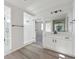 Modern bathroom with white cabinets, quartz countertop, and walk-in shower at 9204 Truckee Ct, Commerce City, CO 80022